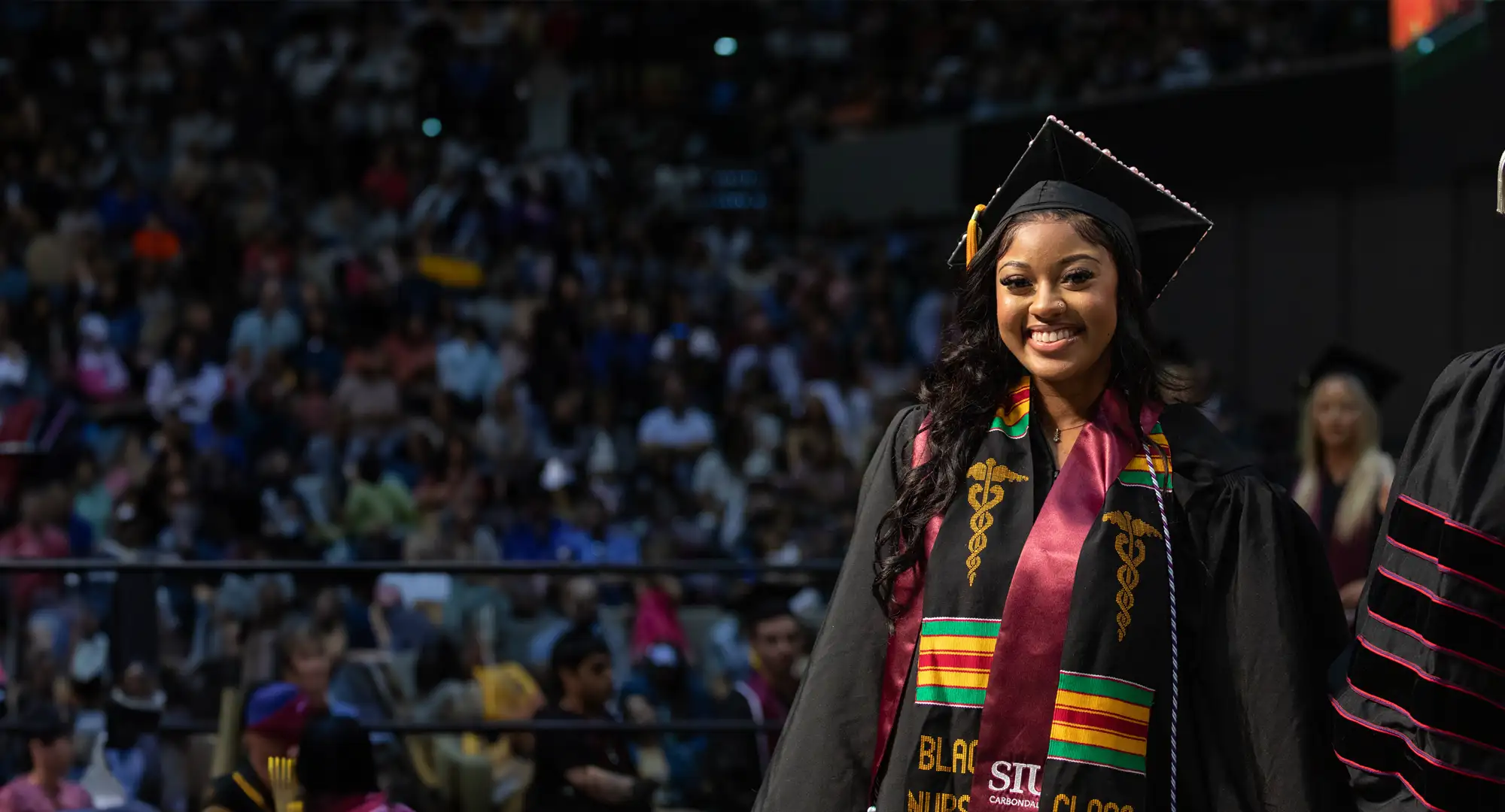 student on stage at commencement